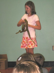 photo of girl holding snake